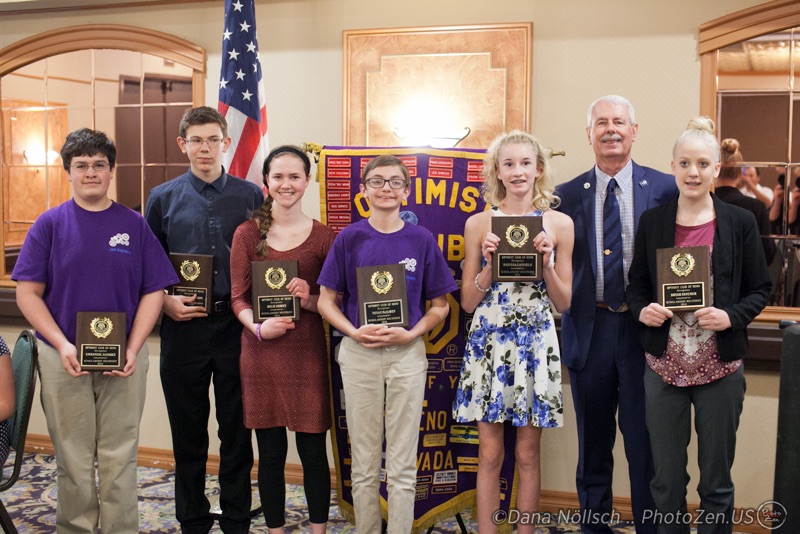 Six juniors receive wooden plaques from an adult member of the Optimist Club of Reno.