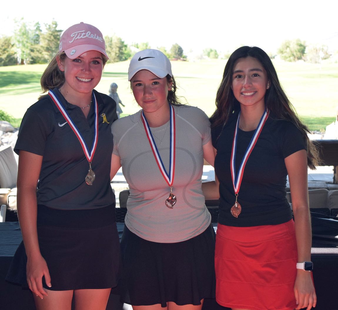 Three female Junior Golf winners, standing wearing their medallion awards from the Reno Optimist Club annual qualifier golf event at Red Hawk Golf Course.