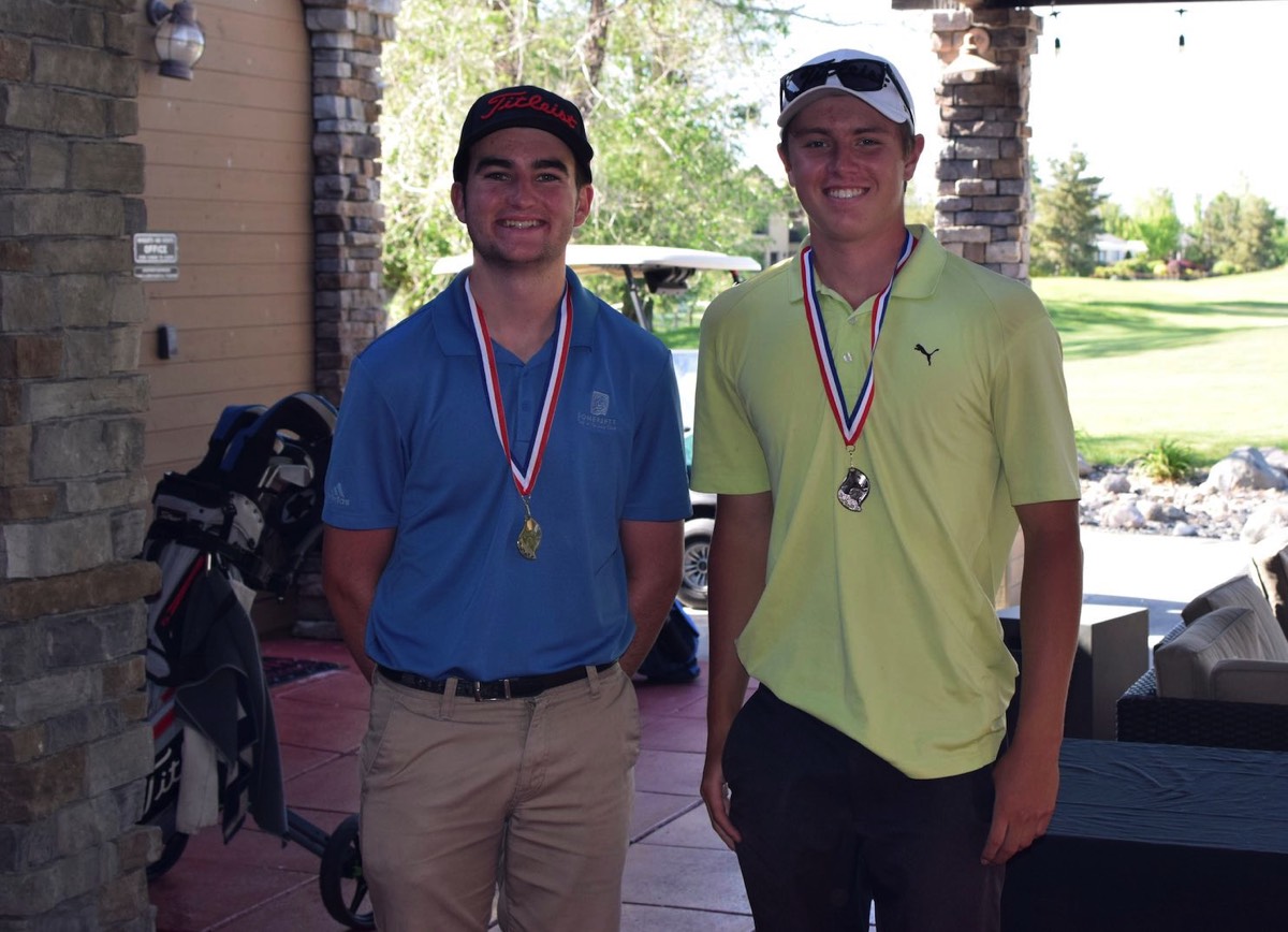 Two male Junior golfers standing, wearing their medallion awards from the Reno Optimist Club annual qualifier golf event at Red Hawk Golf Course.